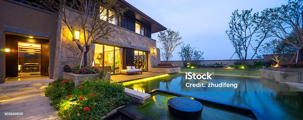 landscape of modern building near pond at dusk